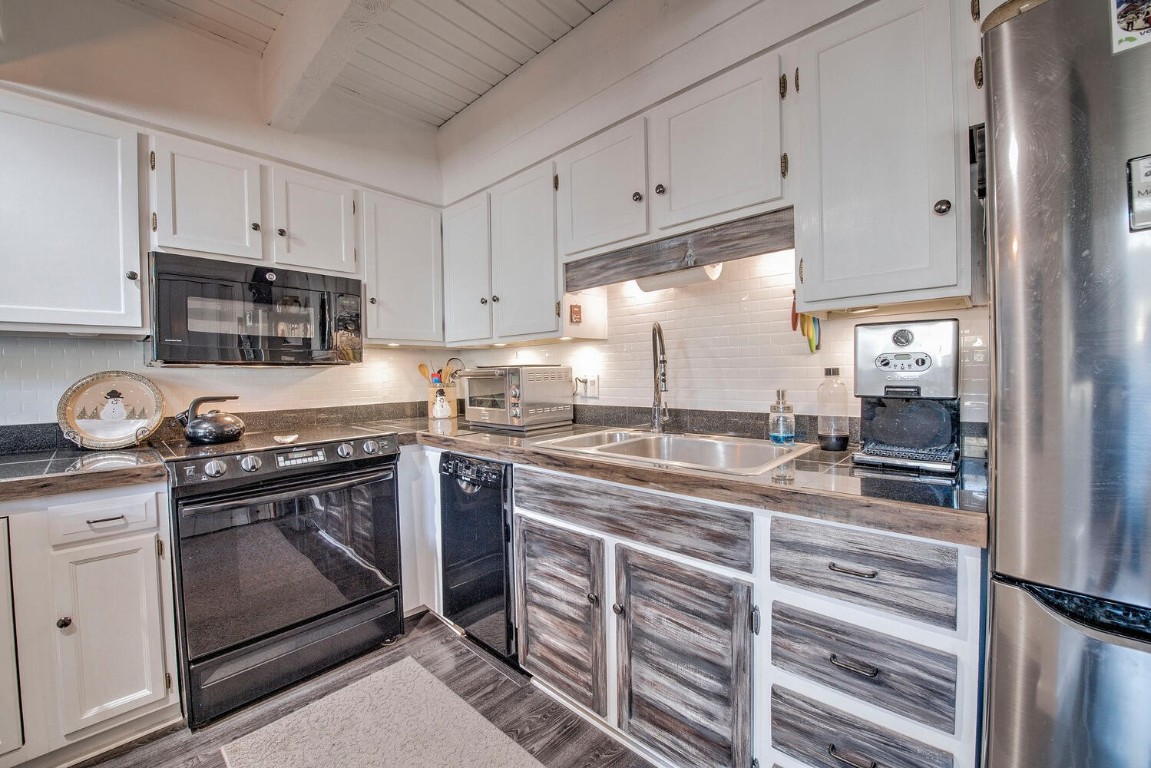 78 Guller Road, Unit 201 Copper Mountain, CO 80443 - Photo 15 of 41 a kitchen with kitchen island granite countertop a stove sink and cabinets