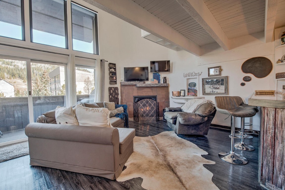 78 Guller Road, Unit 201 Copper Mountain, CO 80443 - Photo 4 of 41 a living room with furniture a fireplace and a large window