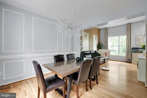 a view of a a dining room with furniture window and wooden floor