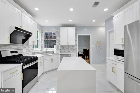a kitchen with a sink a stove and refrigerator