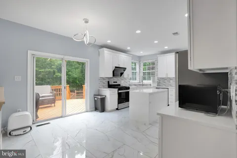 a kitchen with refrigerator and cabinets