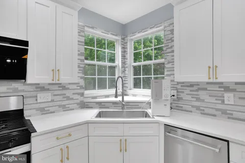 a kitchen with a sink and cabinets
