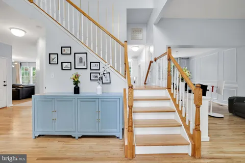 a view of staircase and kitchen with wooden floor