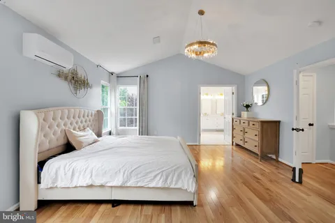 a bedroom with a bed and a chandelier