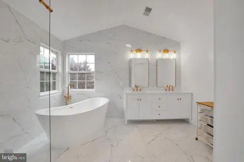 a bathroom with a bathtub sink and mirror