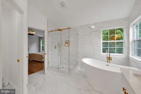 a bathroom with a tub shower and sink