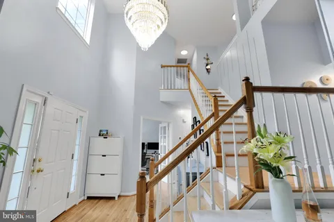 a view of entryway and hall with wooden floor