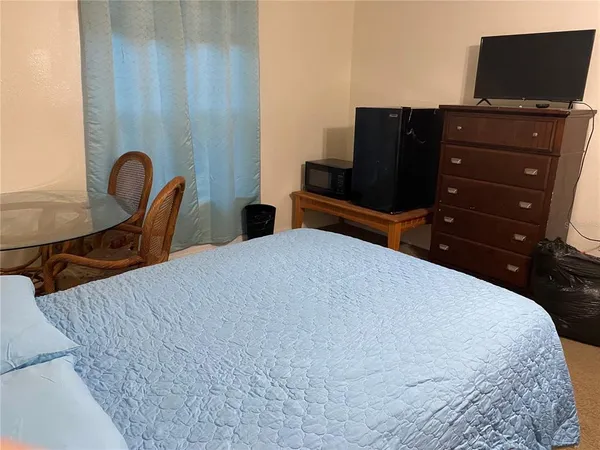 a bedroom with furniture and wooden floor