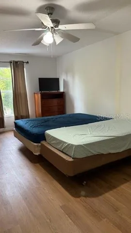 a bedroom with a bed and a chandelier