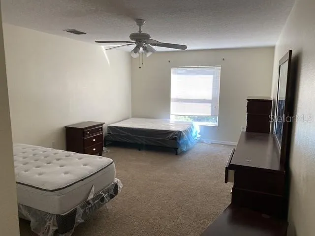 a bedroom with bed and window