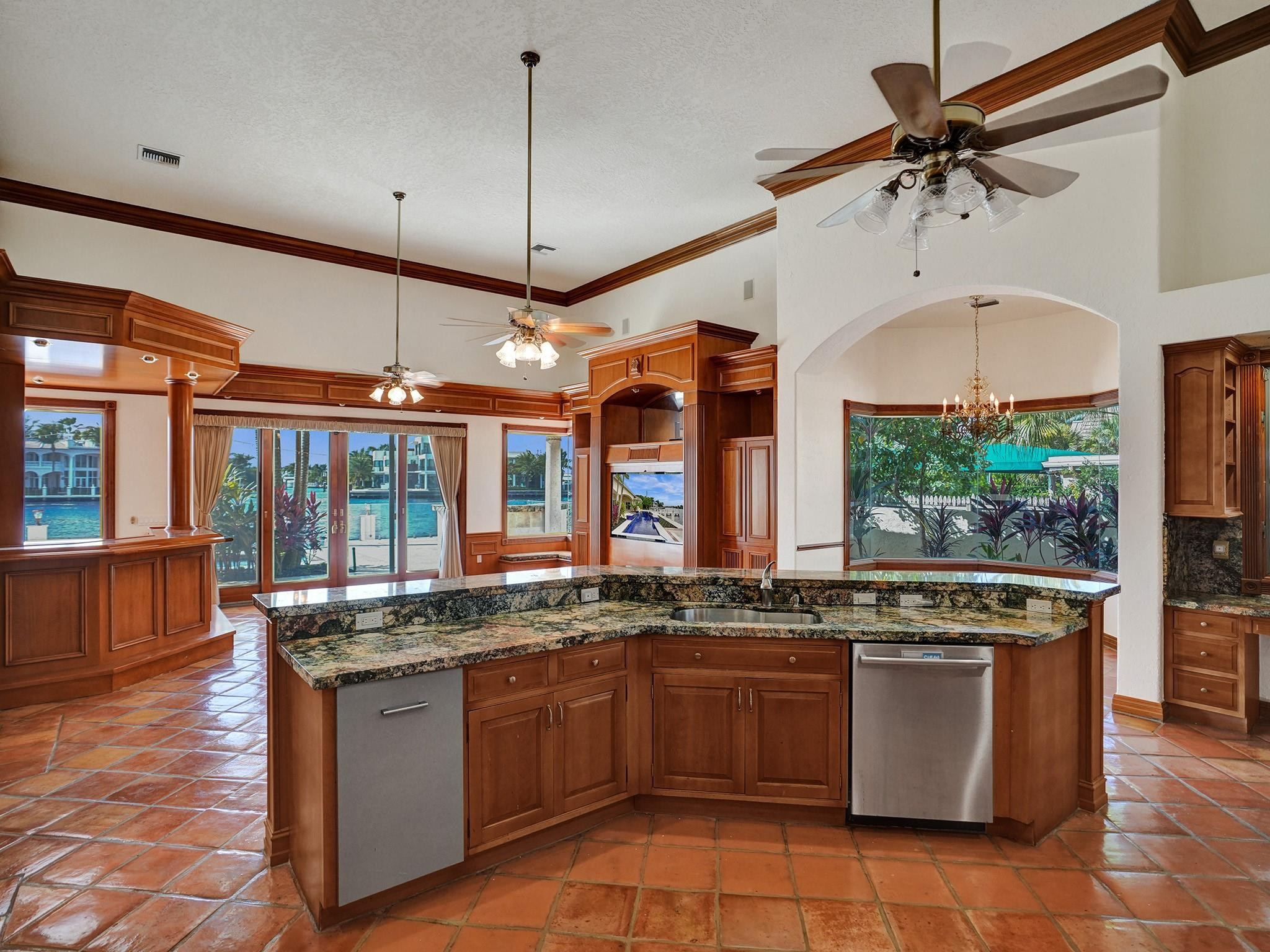 21 Saranac Road Sea Ranch Lakes, FL 33308 - Photo 11 of 35 a kitchen with granite countertop a stove a sink and a counter