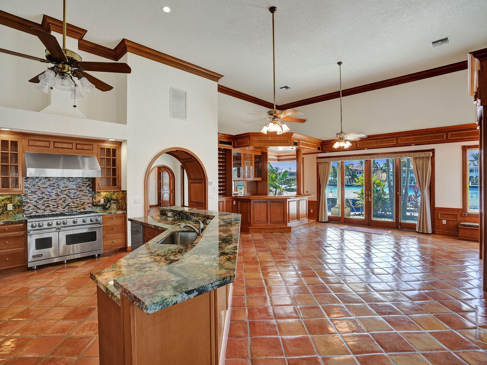 21 Saranac Road Sea Ranch Lakes, FL 33308 - Photo 14 of 35 a view of a kitchen with a stove cabinets and a floor to ceiling window
