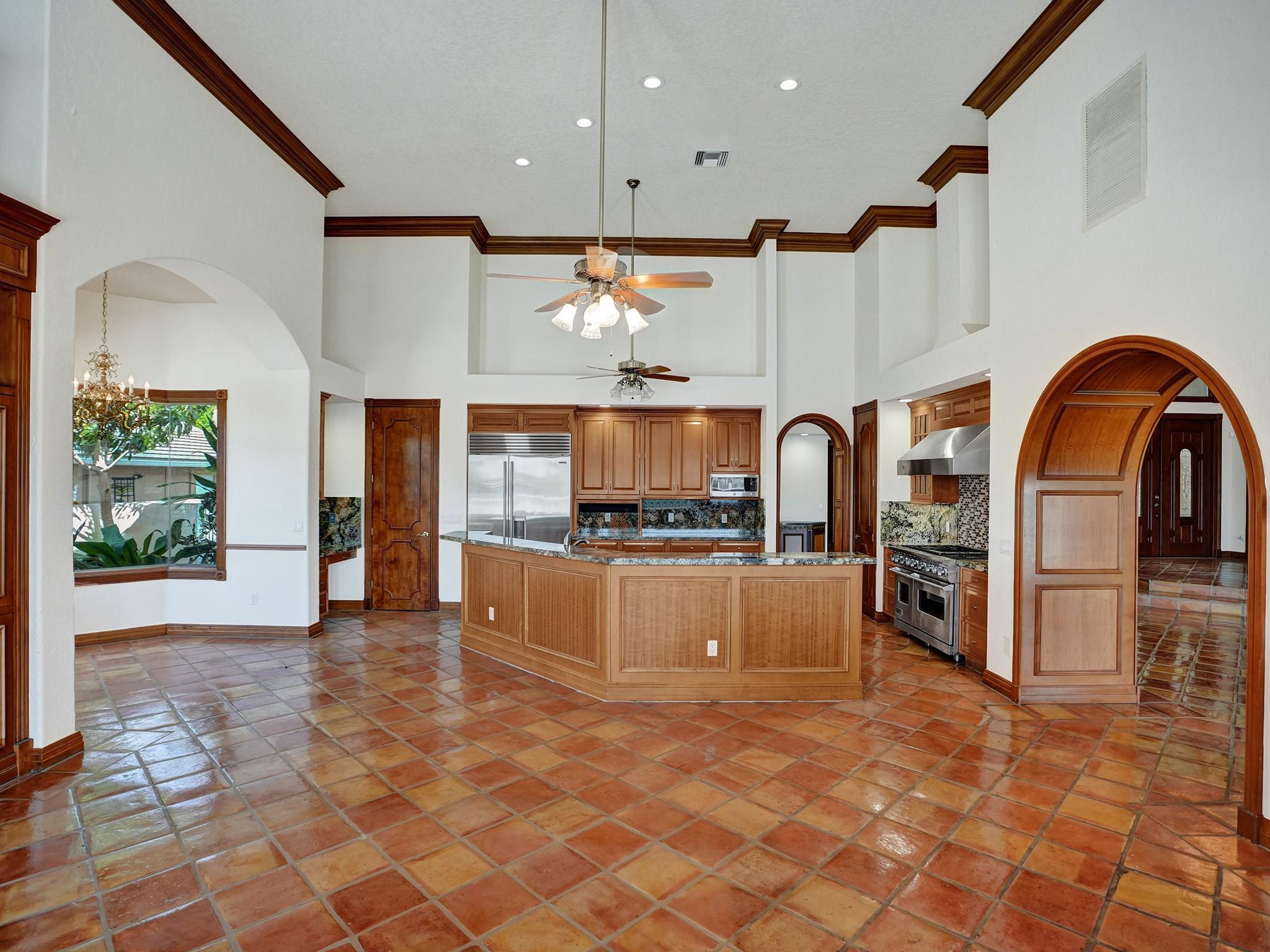 21 Saranac Road Sea Ranch Lakes, FL 33308 - Photo 15 of 35 a view of kitchen with refrigerator stove and wooden cabinets