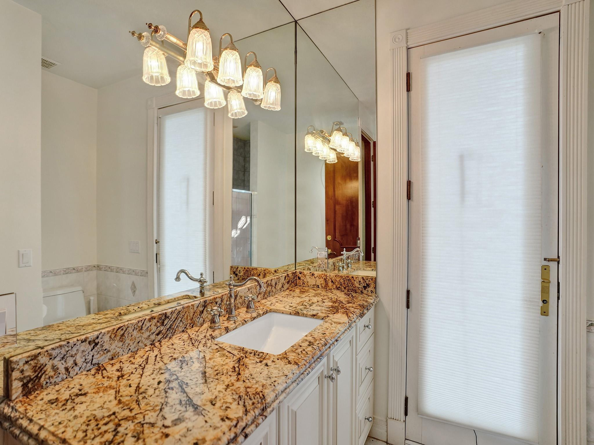21 Saranac Road Sea Ranch Lakes, FL 33308 - Photo 21 of 35 a bathroom with a granite countertop sink and a mirror