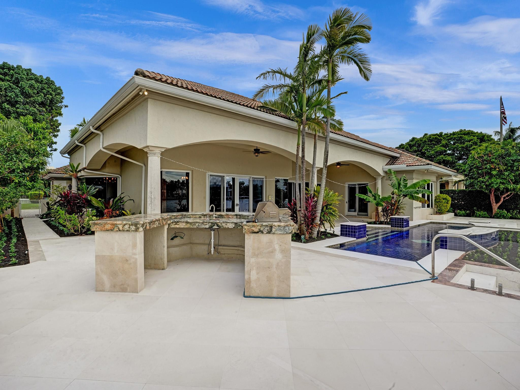 21 Saranac Road Sea Ranch Lakes, FL 33308 - Photo 22 of 35 a view of a white house with couches chairs and potted plants