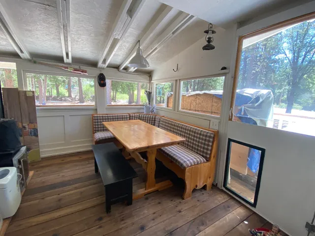 a view of a hallway with wooden floor and door