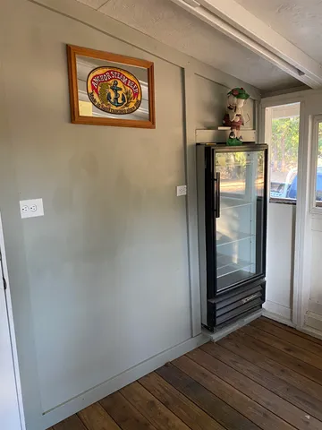 a view of empty room with a wooden floor and cabinet