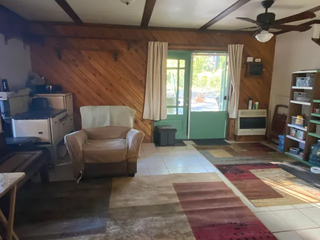 a living room with hard wood floors and a bed