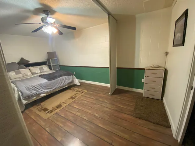 a spacious bedroom with a bed and a shower