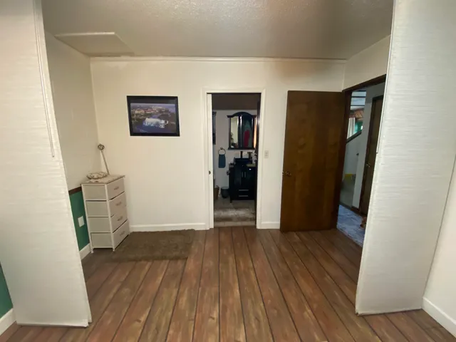 a bedroom with a bed and flat screen tv