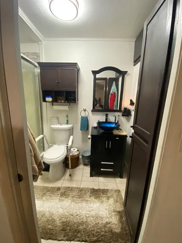 a view of a patio with lawn chairs next to a yard