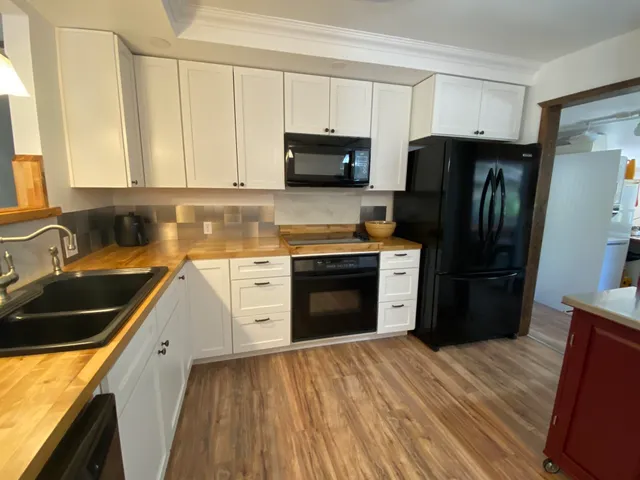 a kitchen with a sink stove and refrigerator