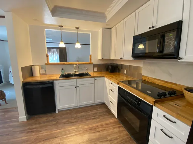 a kitchen with a sink cabinets and window