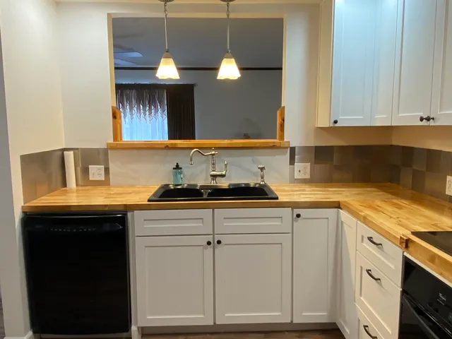 a view of a kitchen with a sink and a window