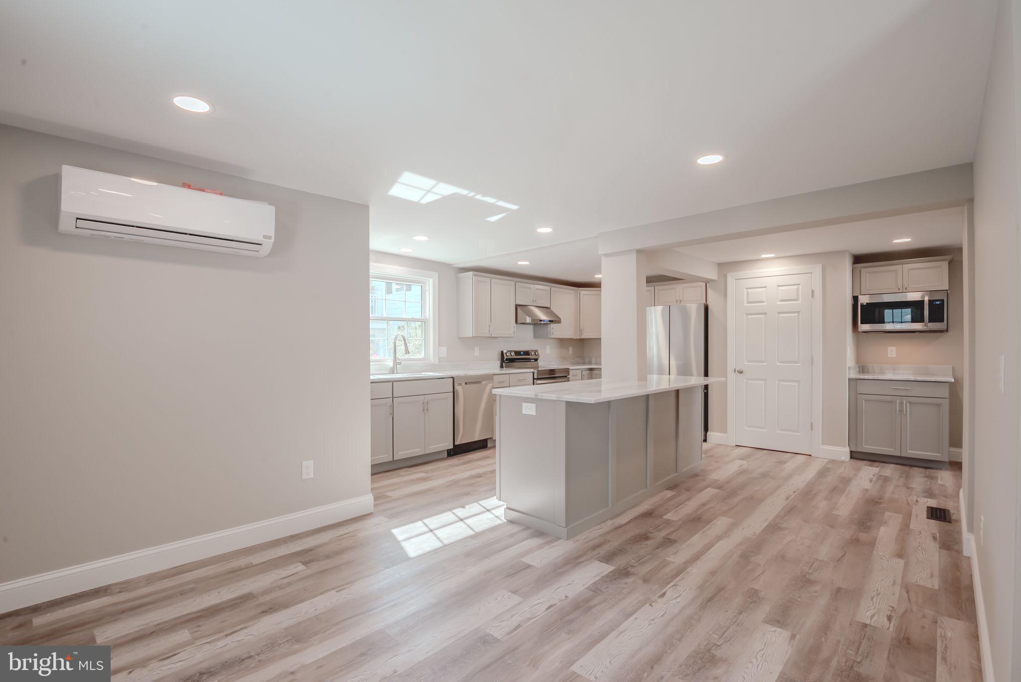 319 Union Street Milton, DE 19968 - Photo 13 of 61 a kitchen with white cabinets and stainless steel appliances