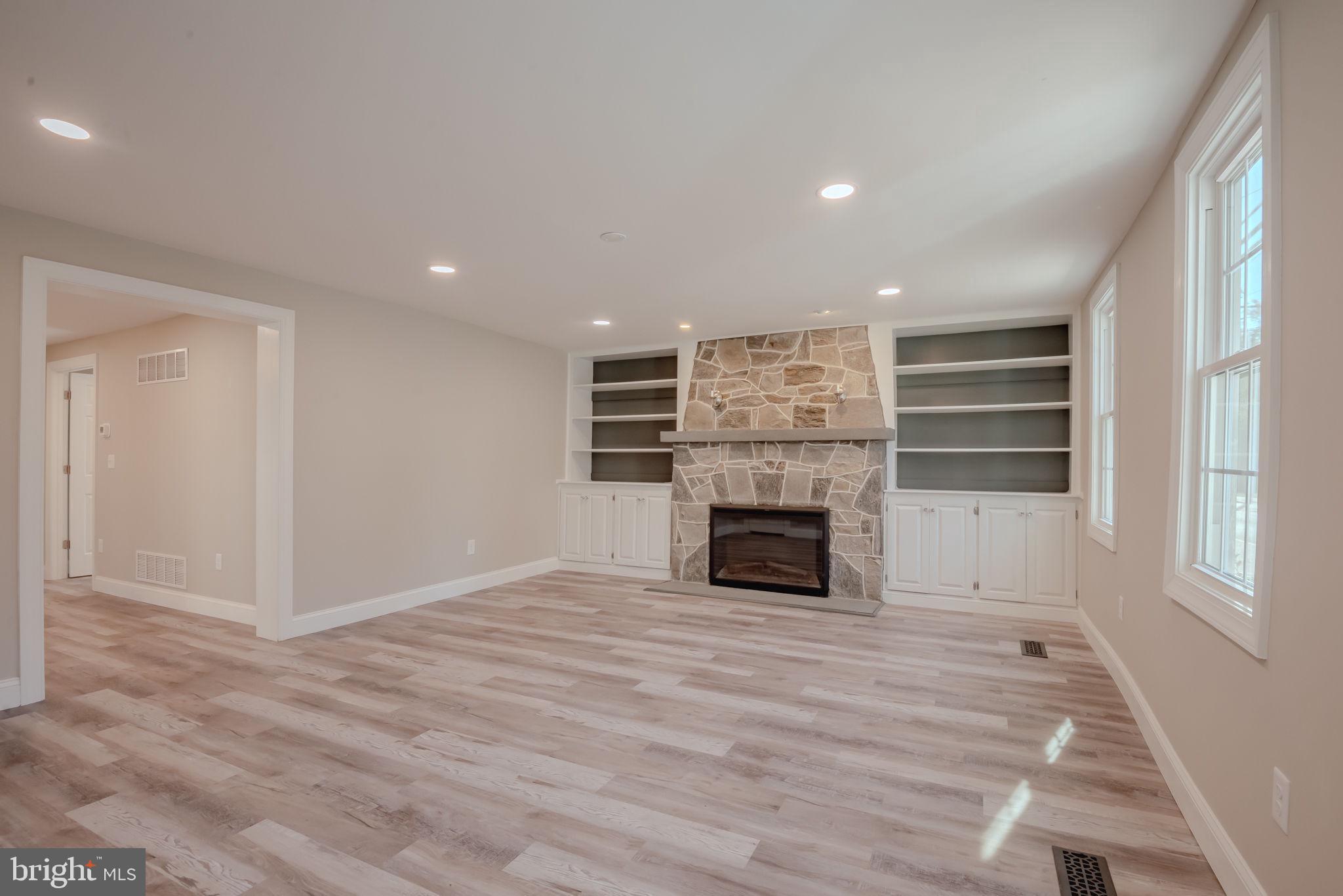 319 Union Street Milton, DE 19968 - Photo 16 of 61 a view of kitchen and empty room with a fireplace