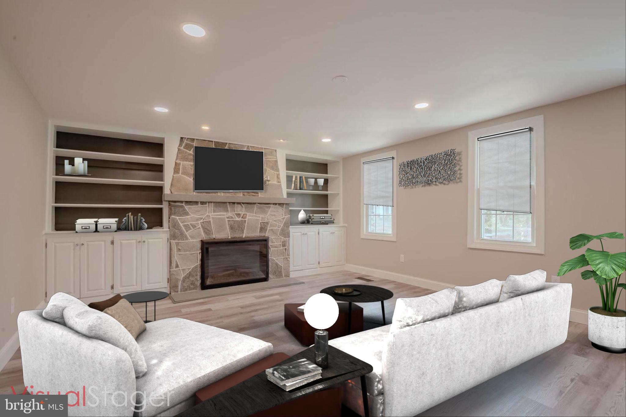 319 Union Street Milton, DE 19968 - Photo 17 of 61 a living room with furniture a fireplace and a flat screen tv