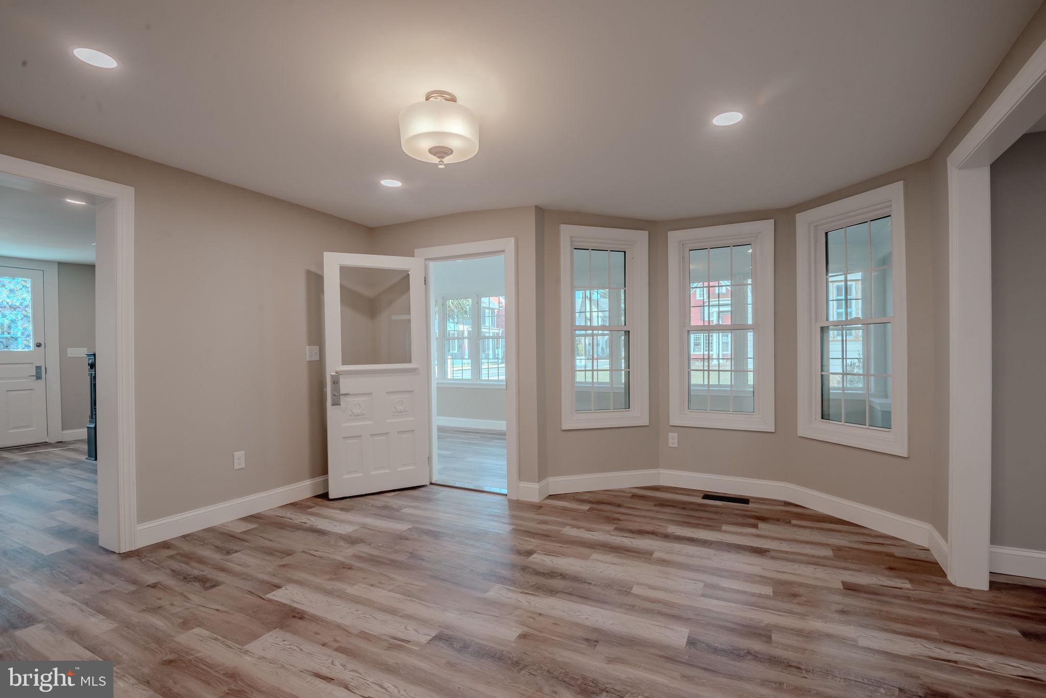 319 Union Street Milton, DE 19968 - Photo 21 of 61 an empty room with wooden floor and windows