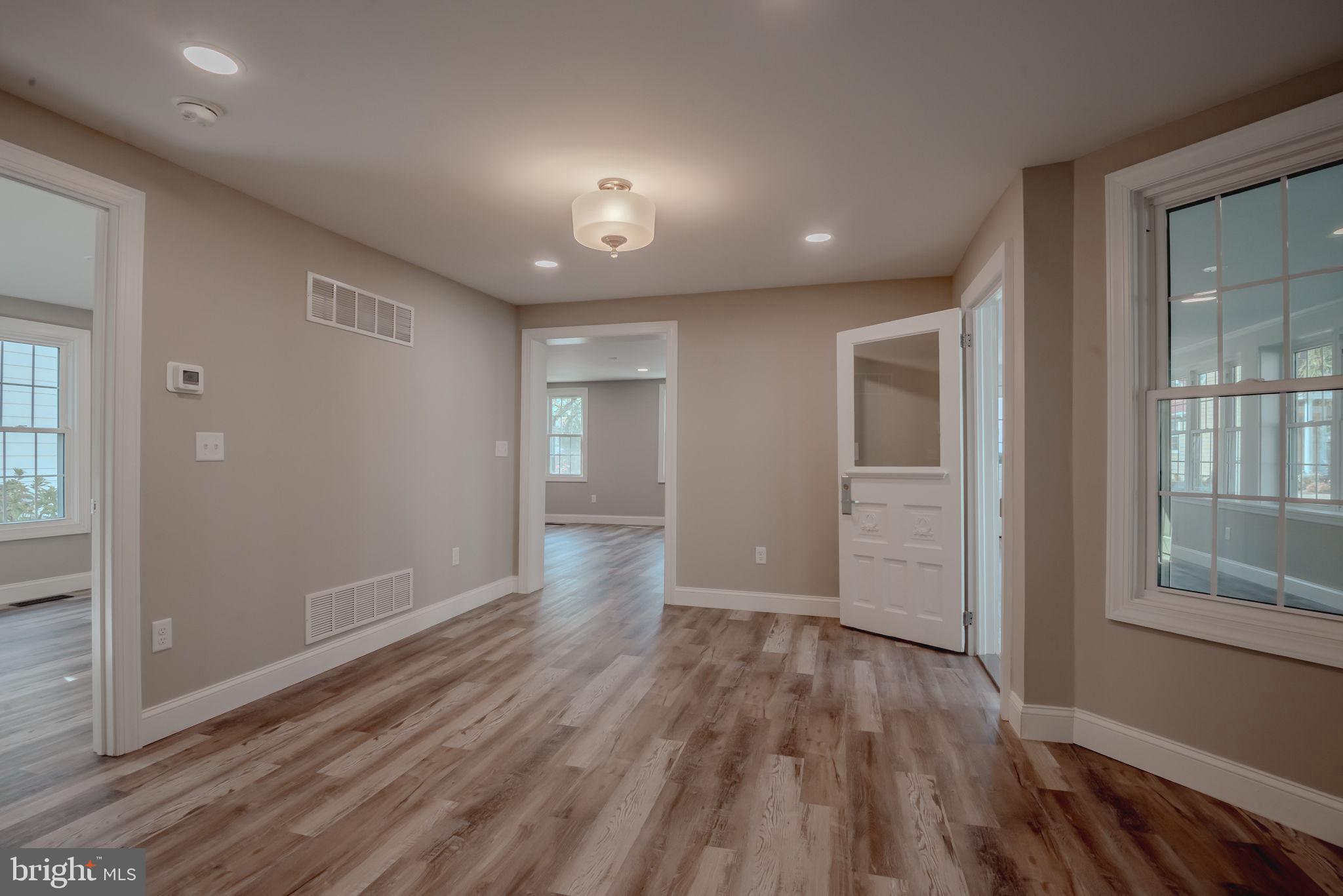 319 Union Street Milton, DE 19968 - Photo 22 of 61 wooden floor in an empty room with windows and wooden floor
