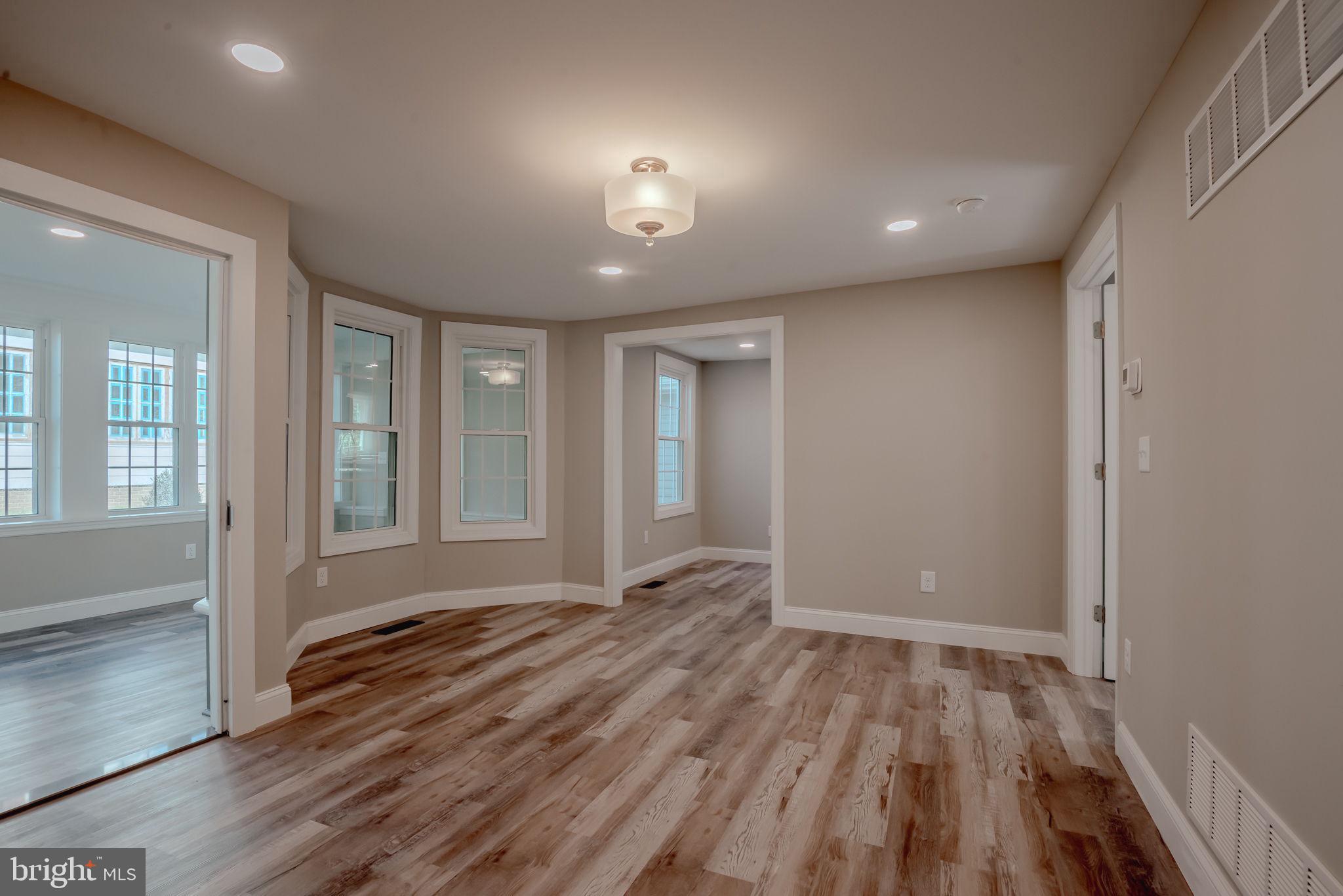 319 Union Street Milton, DE 19968 - Photo 23 of 61 a view of an empty room with wooden floor and a window