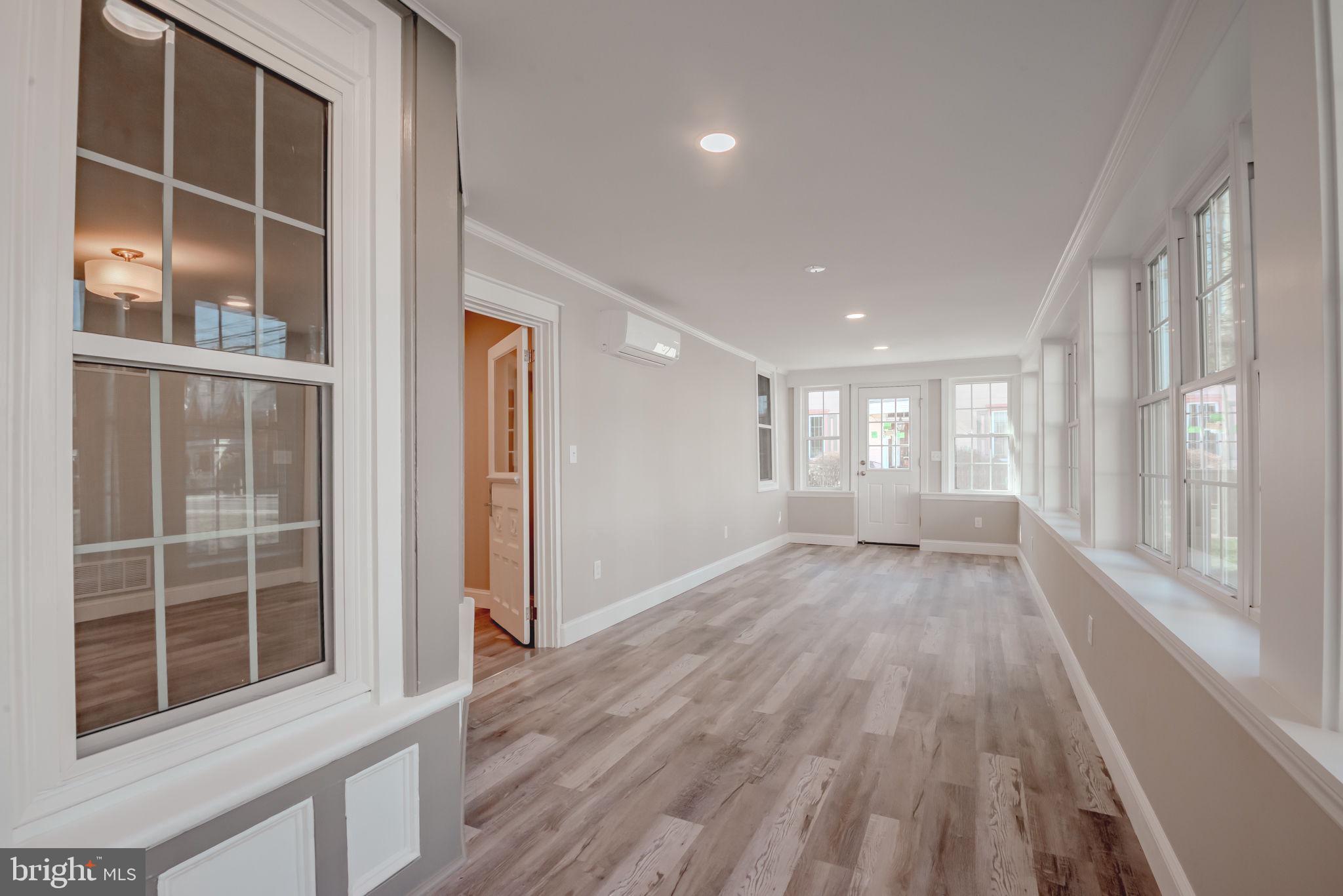 319 Union Street Milton, DE 19968 - Photo 25 of 61 a view of an empty room with a window and wooden floor