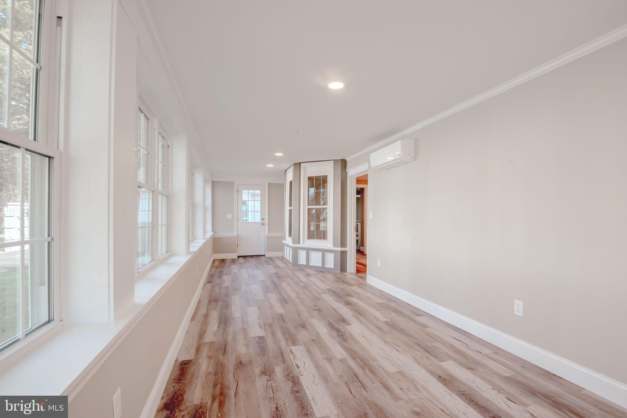 319 Union Street Milton, DE 19968 - Photo 26 of 61 a view of an empty room with wooden floor and a window