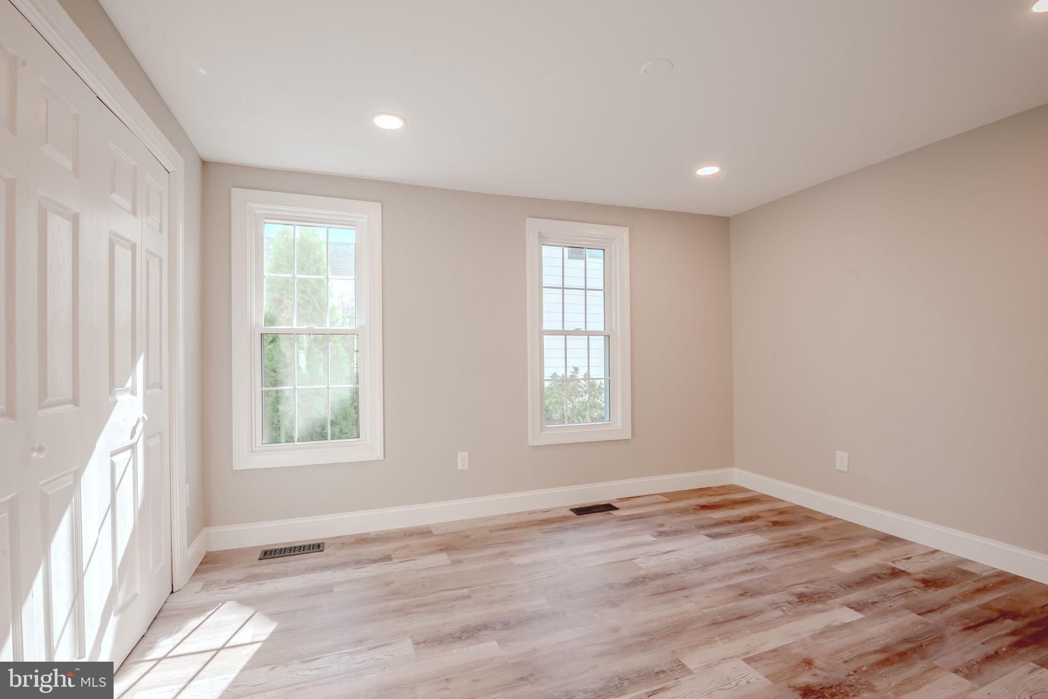 319 Union Street Milton, DE 19968 - Photo 29 of 61 an empty room with wooden floor and windows