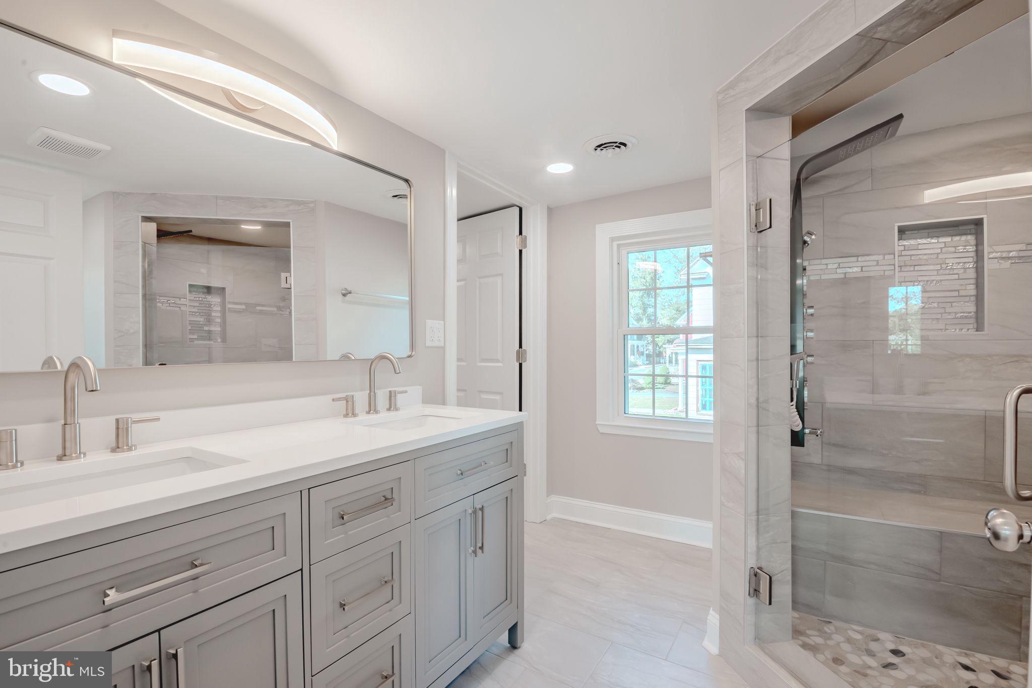 319 Union Street Milton, DE 19968 - Photo 39 of 61 a bathroom with a shower sink and mirror