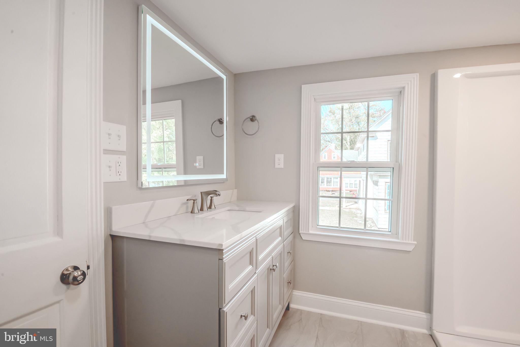 319 Union Street Milton, DE 19968 - Photo 47 of 61 a bathroom with a sink a vanity and a window