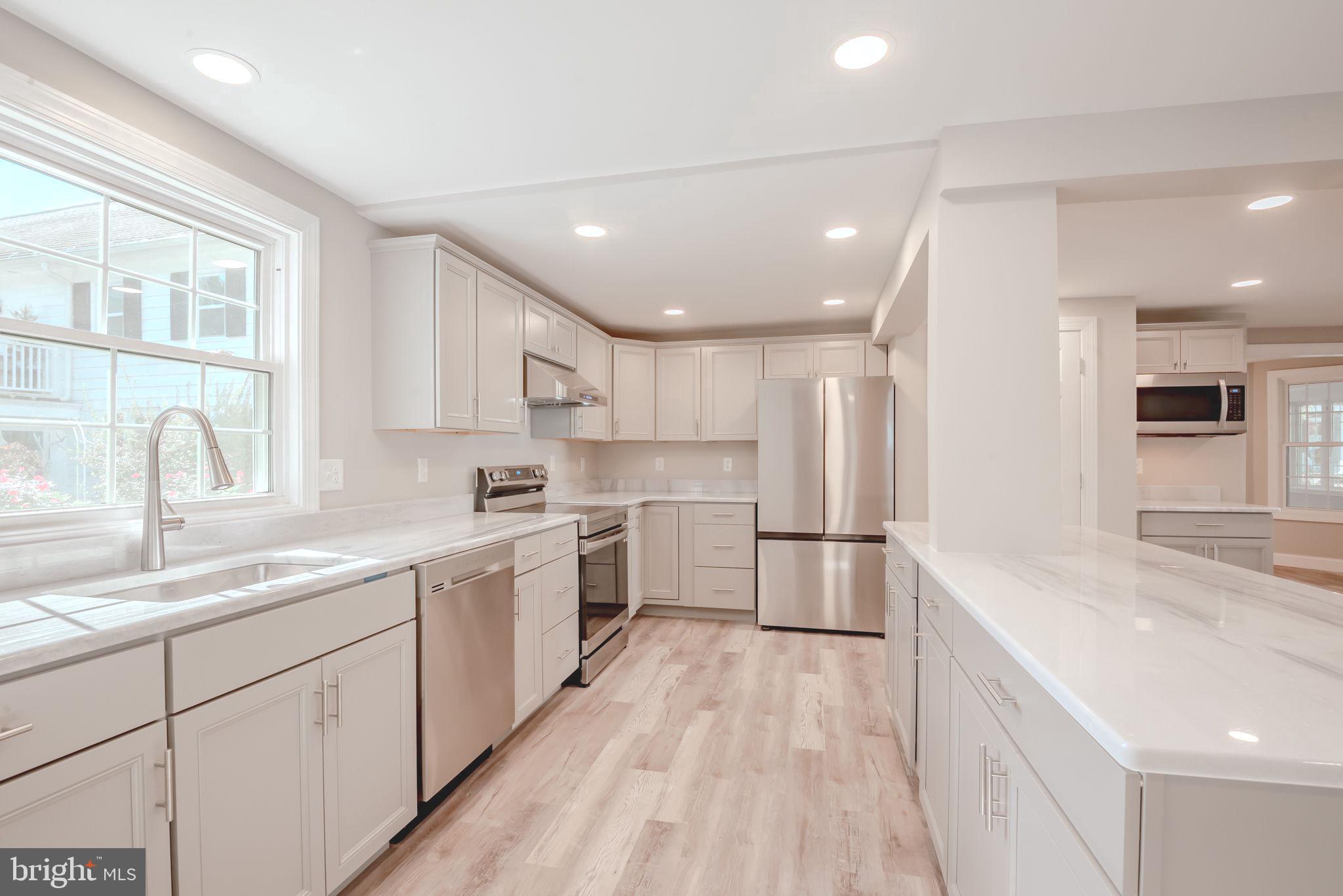 319 Union Street Milton, DE 19968 - Photo 9 of 61 a kitchen with a sink stainless steel appliances and cabinets
