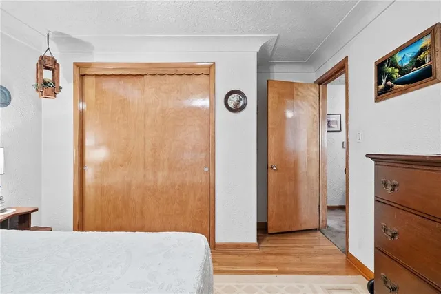 a bedroom with a bed and a mirror