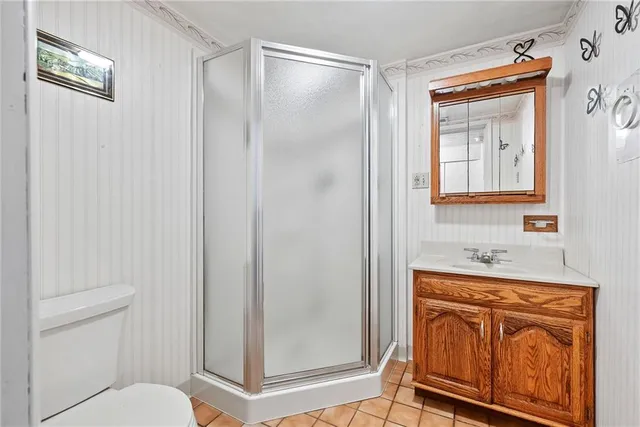 a living room with furniture a ceiling fan and a floor to ceiling window