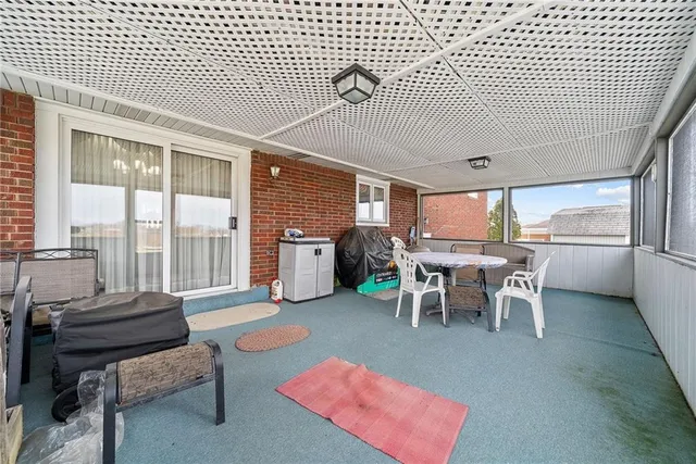 a view of a patio with dining table and chairs