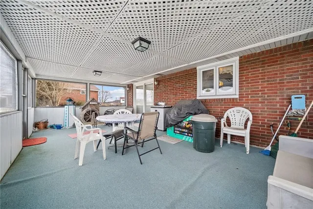 a dining room with furniture and a floor to ceiling window