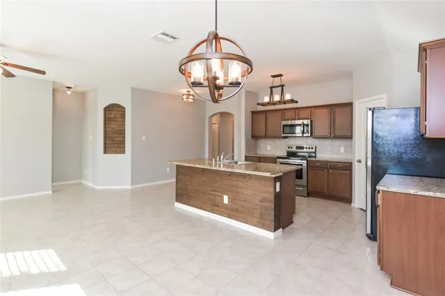 a kitchen with a stove a sink and a refrigerator