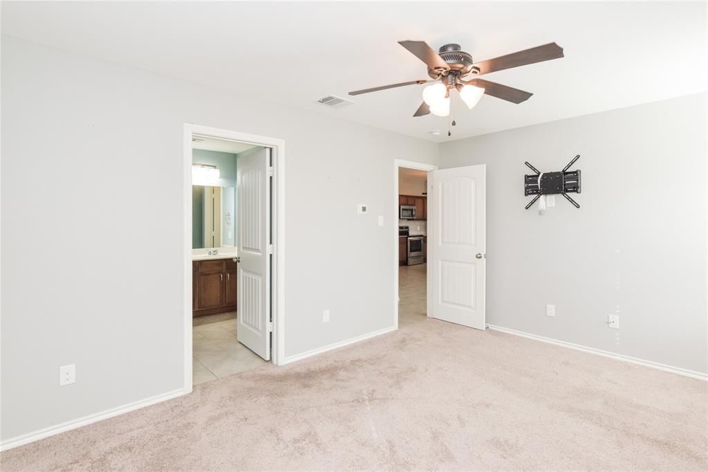 1406 Slate Street Princeton, TX 75407 - Photo 15 of 25 an empty room with a ceiling fan and a window