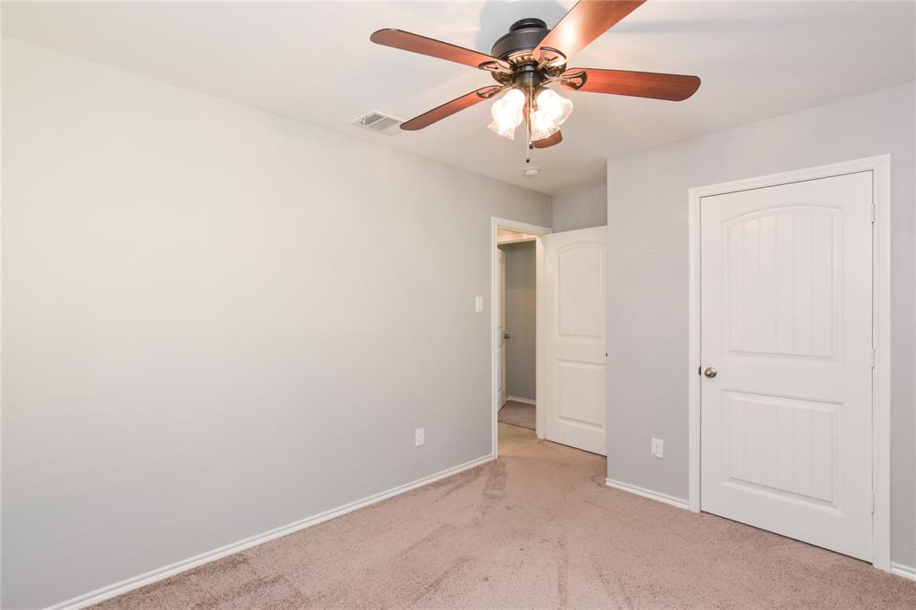 1406 Slate Street Princeton, TX 75407 - Photo 20 of 25 an empty room with a fan and a fan