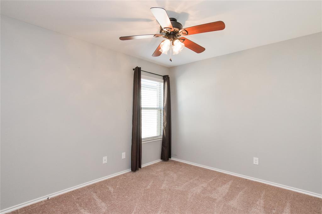 1406 Slate Street Princeton, TX 75407 - Photo 21 of 25 an empty room with windows and fan