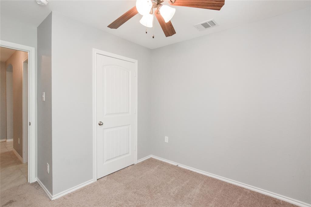 1406 Slate Street Princeton, TX 75407 - Photo 22 of 25 an empty room with a window and a ceiling fan