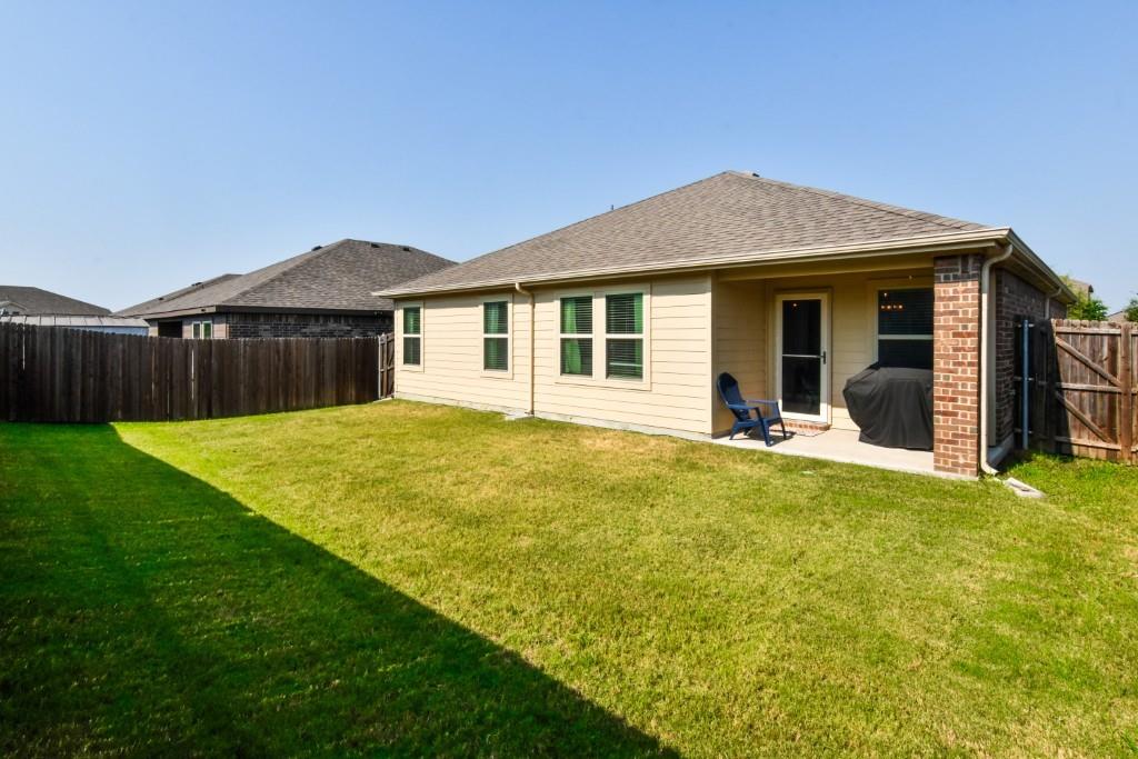 1406 Slate Street Princeton, TX 75407 - Photo 24 of 25 a view of a house with a backyard and a small yard